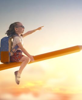 Back to school! Happy cute industrious child flying on the pencil on background of sunset sky. Concept of education and reading. The development of the imagination.